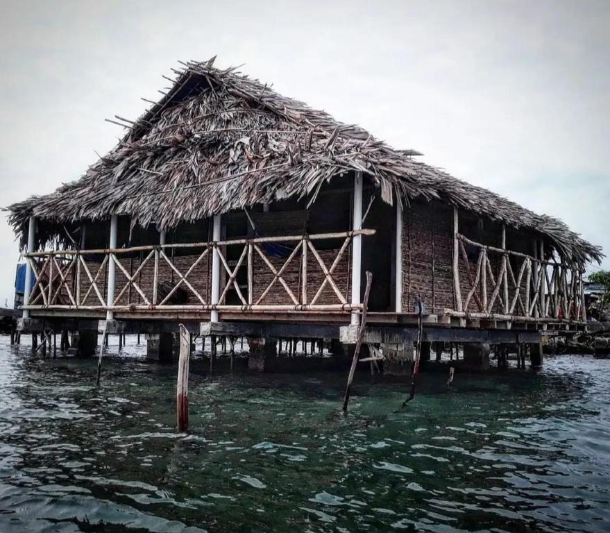 a house on a pier in the water at Private Traditional Hut on the water with 2 rooms in Wichubualá