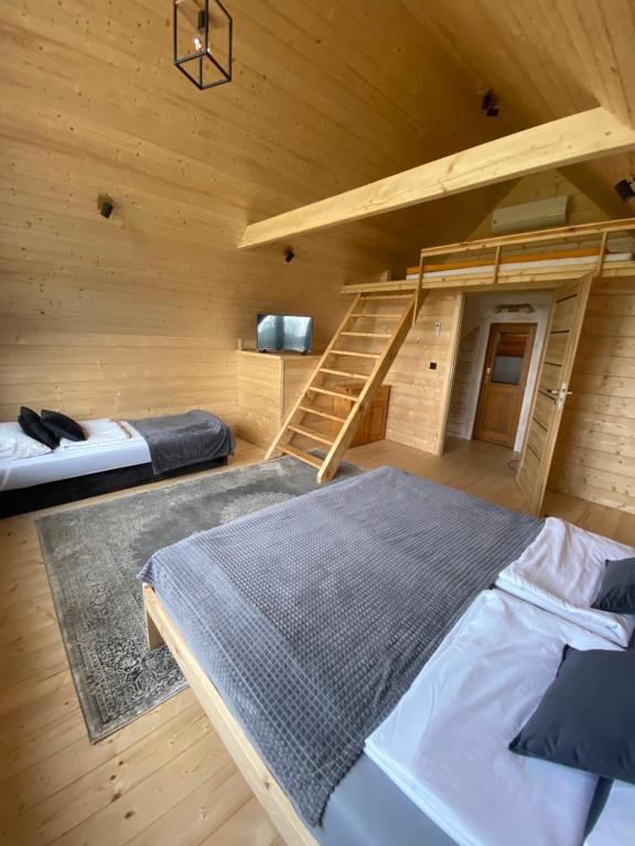 a room with two beds and a bunk bed at Dom wakacyjny nad jez Orzysz in Orzysz