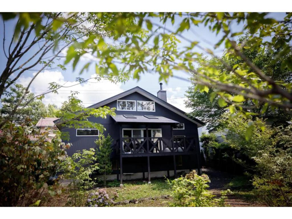 a black house with a balcony in a yard at MORIHAKU - Vacation STAY 36402v in Kutsukake