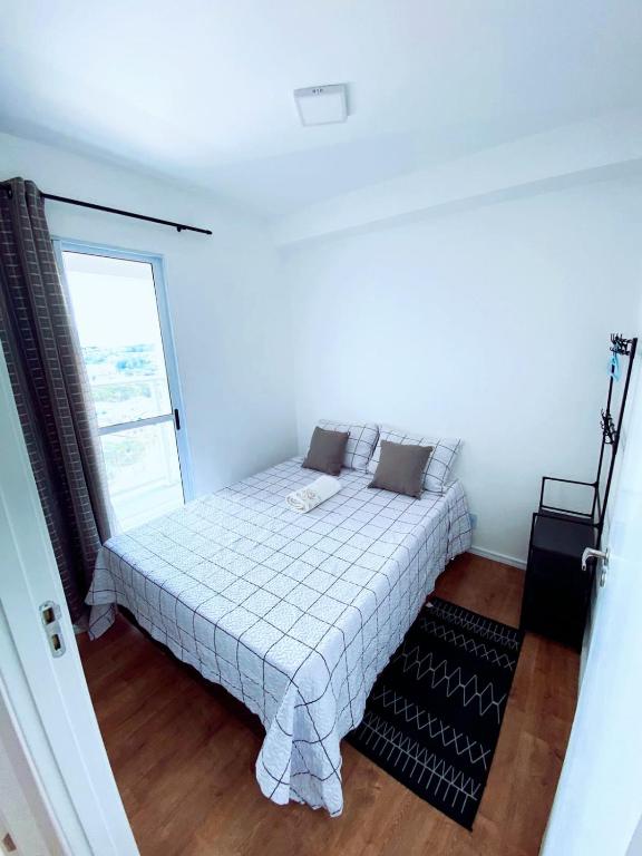 um quarto com uma cama e uma janela em Apartamento no Butantã em São Paulo