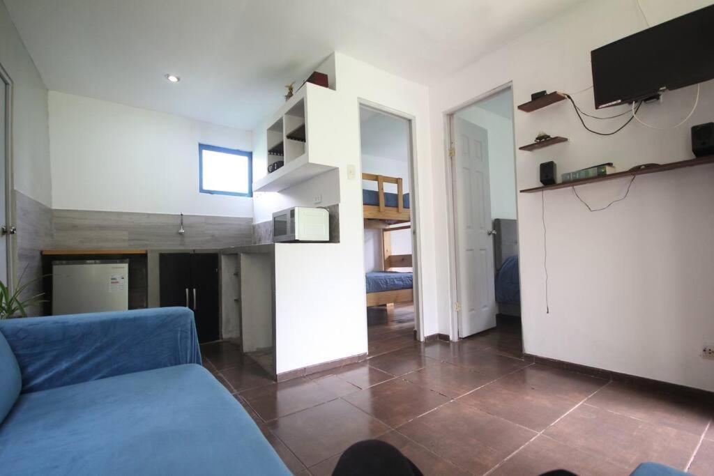 ein Wohnzimmer mit einem blauen Sofa und einem TV in der Unterkunft House for 3 people in Urubamba in Urubamba