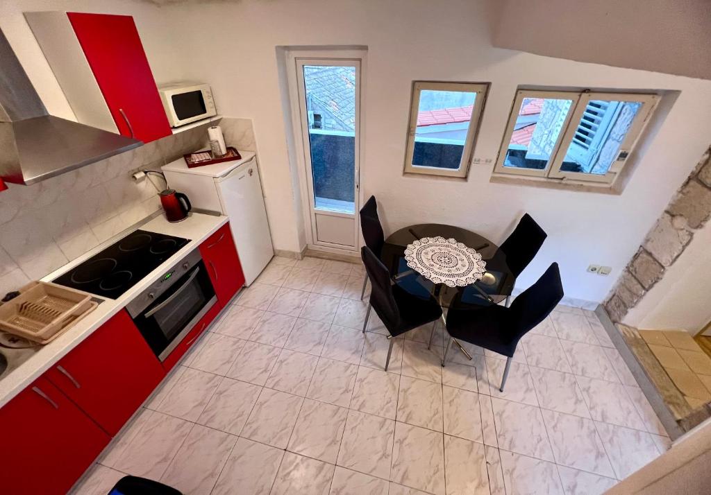 an overhead view of a kitchen with a table and chairs at Apartments Tudor Nikola in Hvar