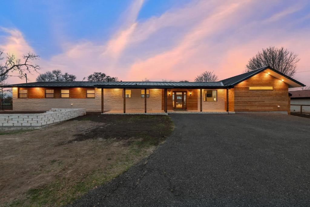 a wooden house with a lot of windows at Guadalupe Bluff Modern House in Kerrville