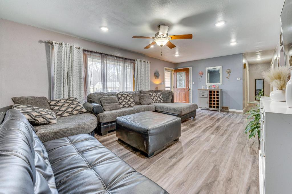 a living room with a couch and a ceiling fan at Newly Remodeled Home in Storm Lake with Private Yard in Storm Lake