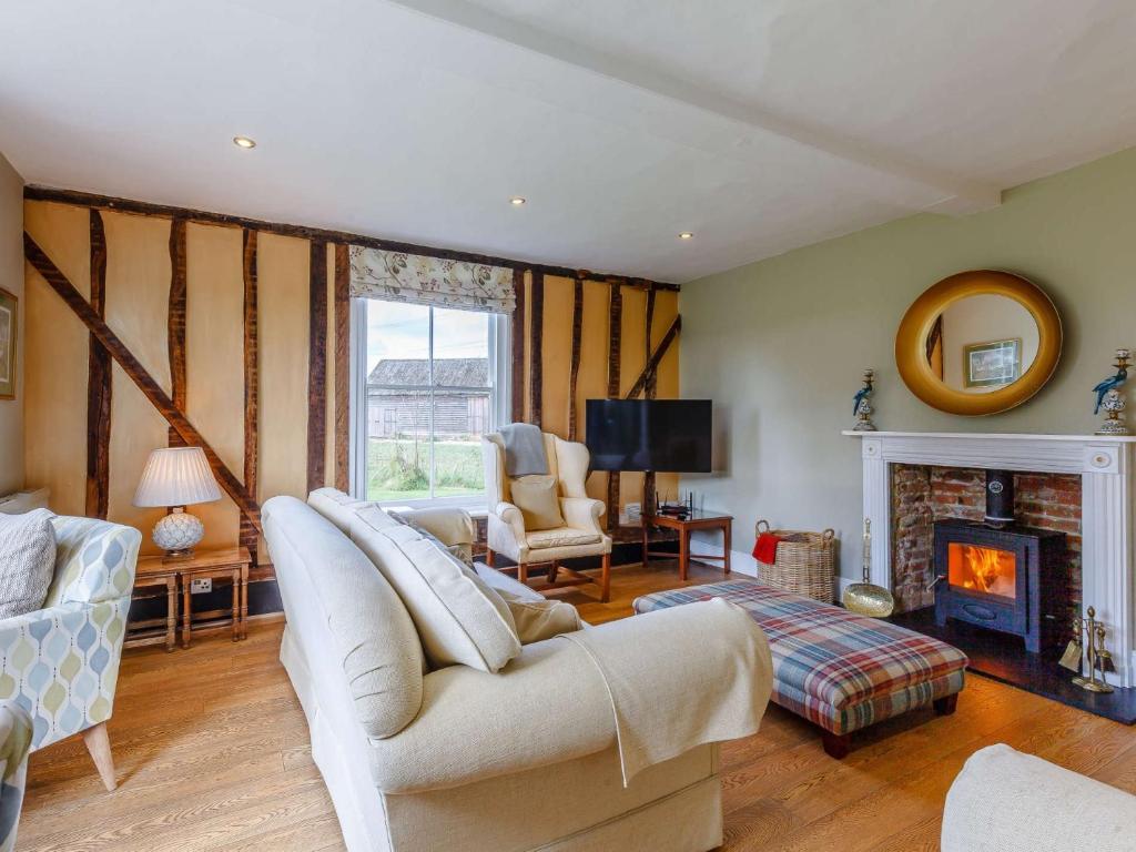 a living room with a couch and a fireplace at 3 Bed in Saffron Walden 85662 in Finchingfield