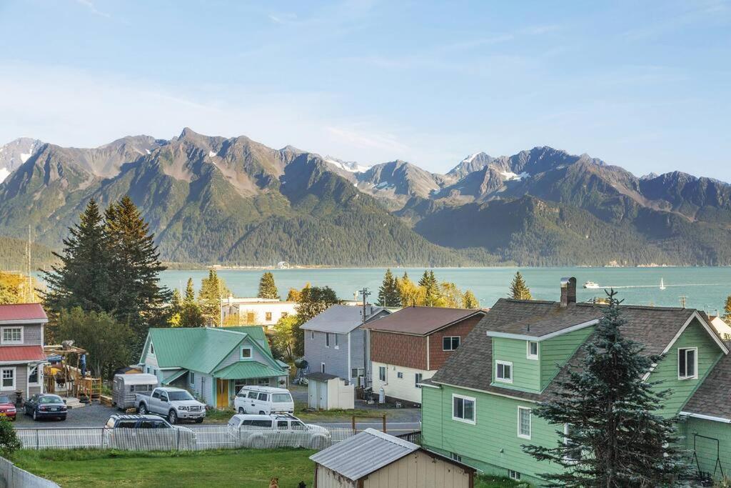 a small town with houses and a lake and mountains at Alaska's Point of View Full Suite in Seward