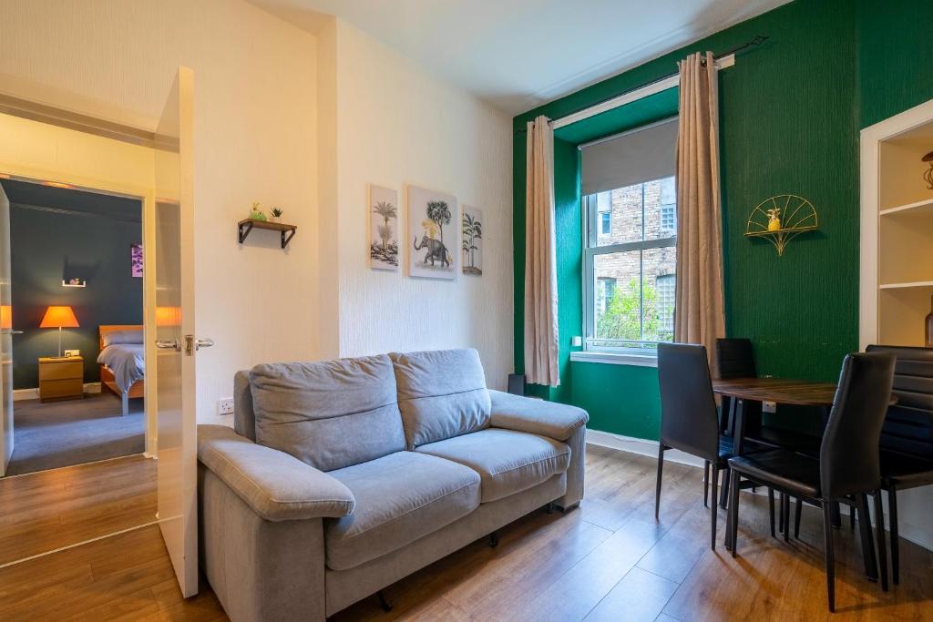 a living room with a couch and a table at The Eden Apartment, Edinburgh City Center in Edinburgh