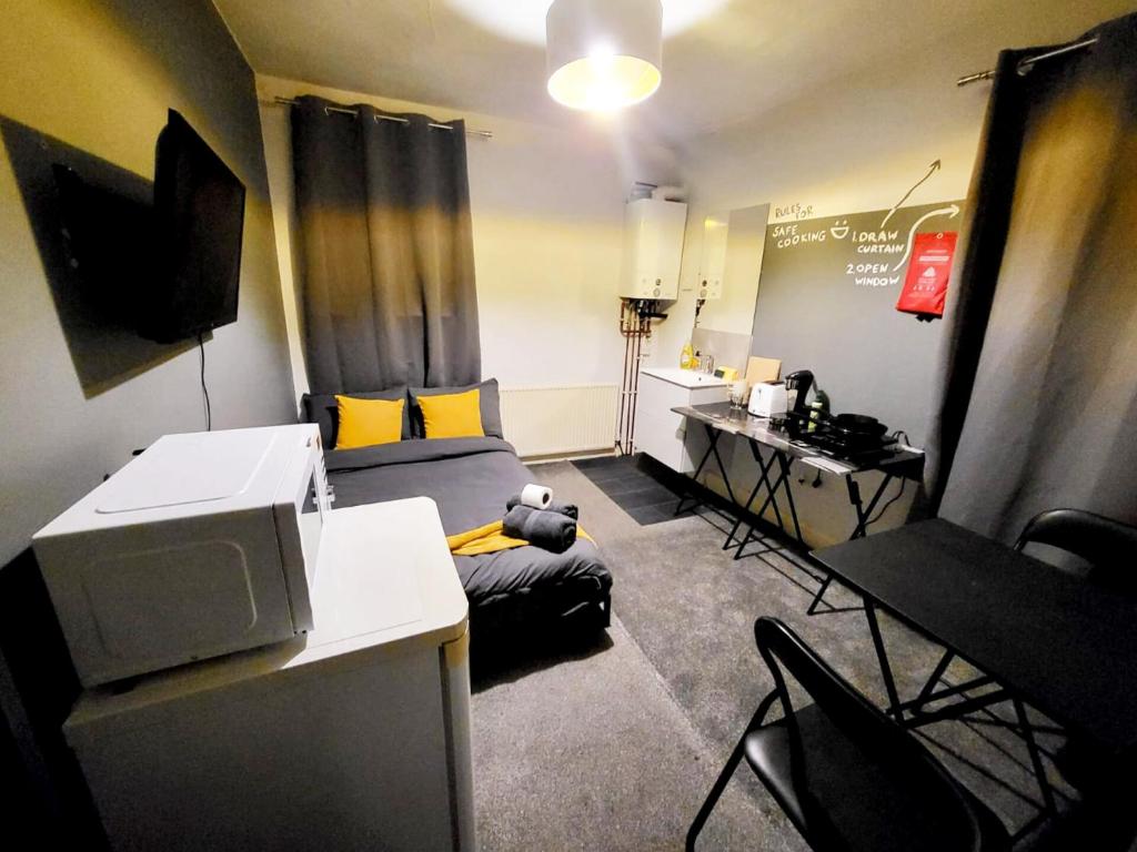 a small living room with a desk and a couch at Stay Sleep Rest - De Grey in Hull