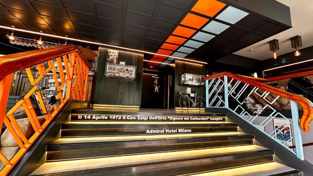 a set of stairs in a building with a sign on it at Admiral Hotel in Milan