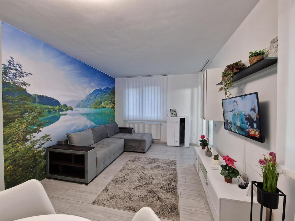 a living room with a large painting on the wall at Blue apartaments in Cluj-Napoca