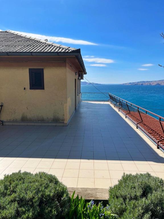 a balcony of a house with a view of the ocean at Apartment Ivanka in Senj