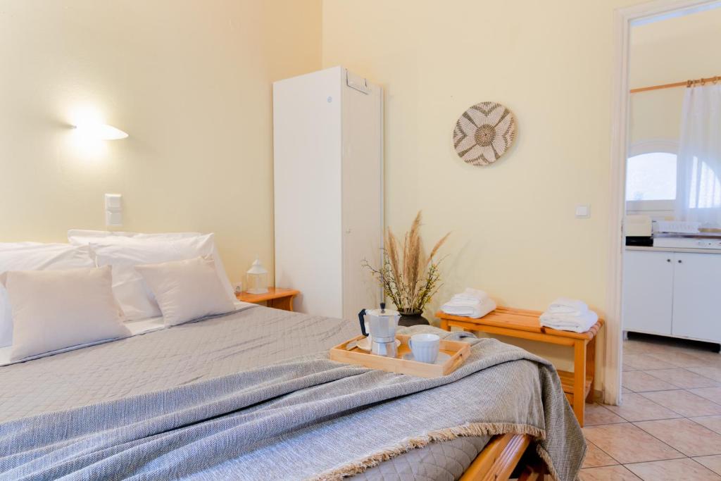 a bedroom with a bed with a tray on it at Almyra Apartments & Studios in Agios Gordios