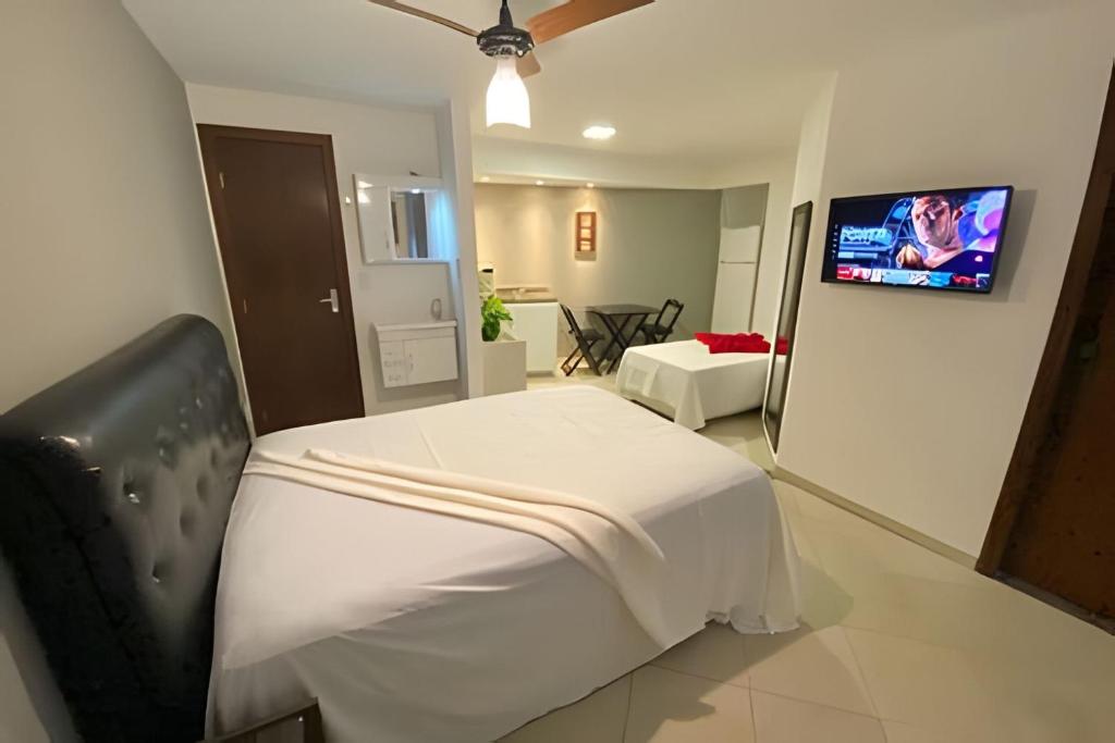 a hospital room with a bed and a flat screen tv at VA Apart Hotel Savassi in Divinópolis