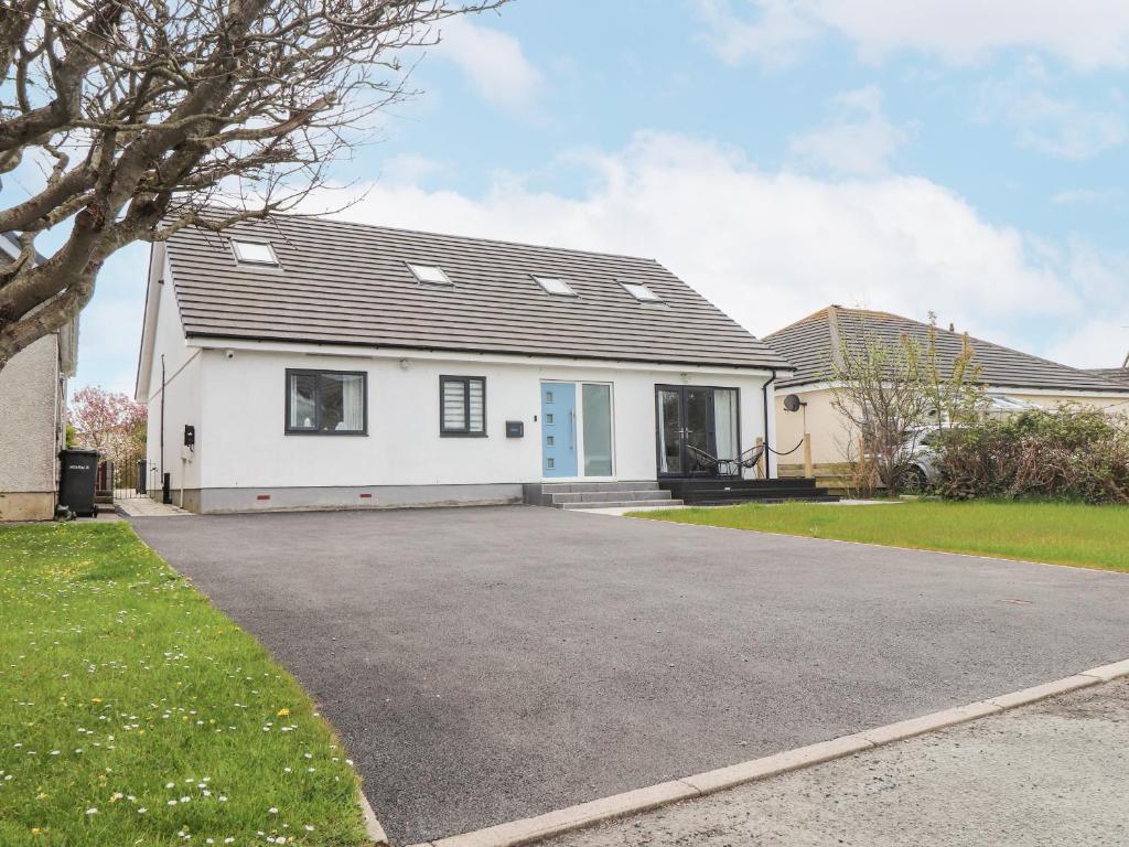 a house with a driveway in front of it at Blue Bay Villa in Holyhead