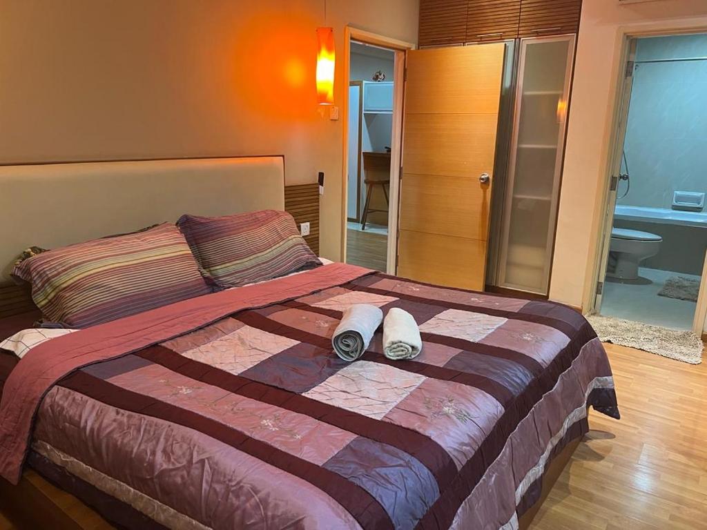 a bedroom with a bed with two slippers on it at Parkview KLCC ITSKAYA 11 in Kuala Lumpur