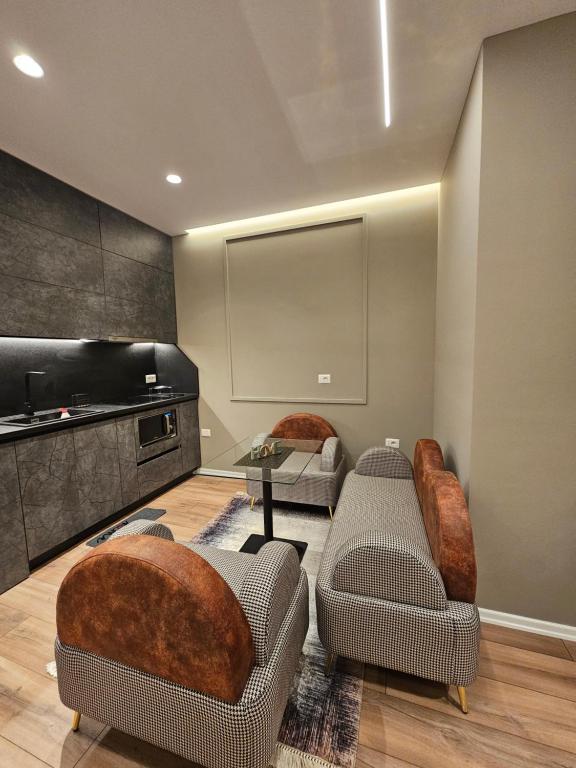 a living room with two couches and a flat screen tv at Tirana Apartment 5 Stars in Kashari