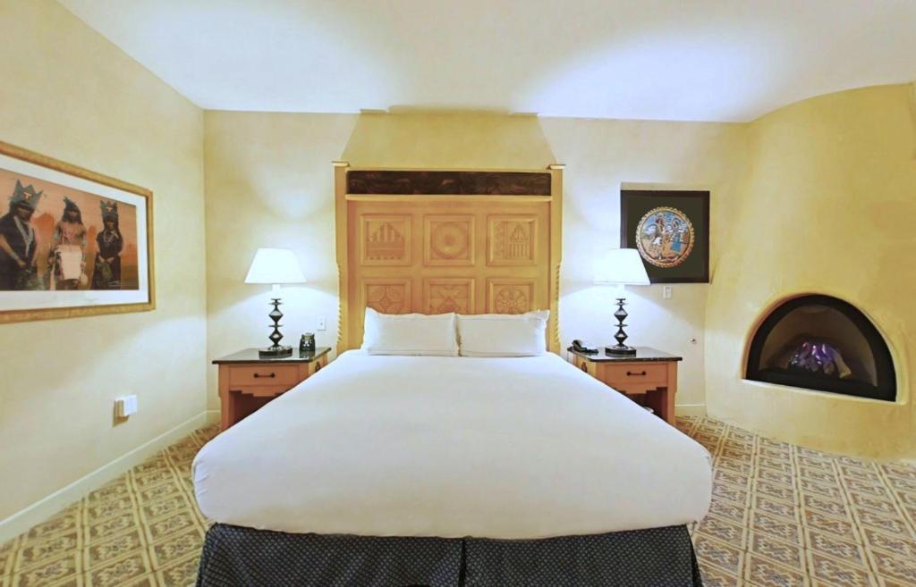 a large white bed in a room with two tables at Hilton Santa Fe Buffalo Thunder in Santa Fe