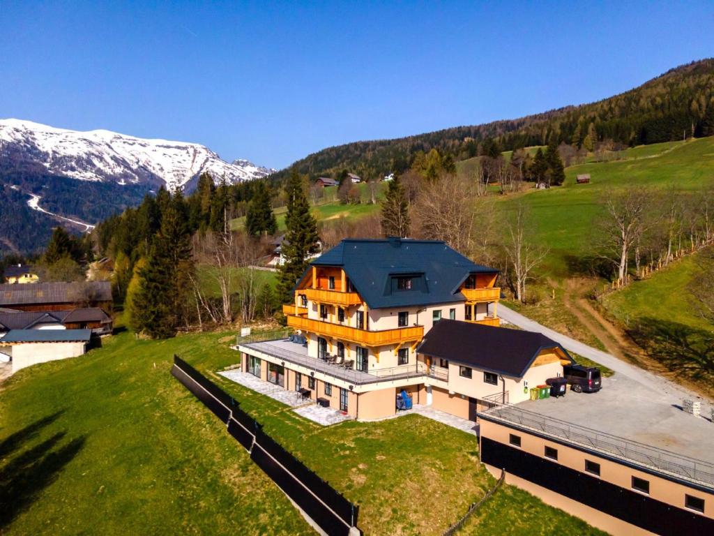 an aerial view of a large house in the mountains at Lärchenhof Top 302 in Mauterndorf