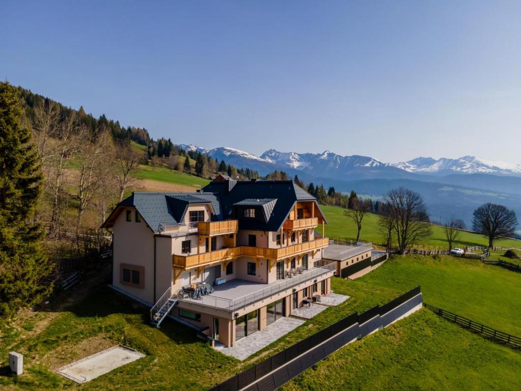 an aerial view of a large house on a hill at Lärchenhof Top 303 in Mauterndorf