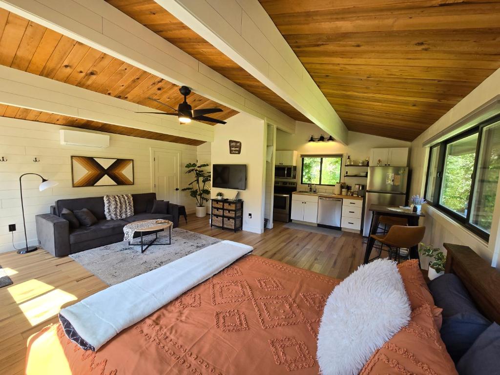 a large living room with a couch and a kitchen at A Restful Studio Near a Creek and Forest - Pet Friendly in Roseburg