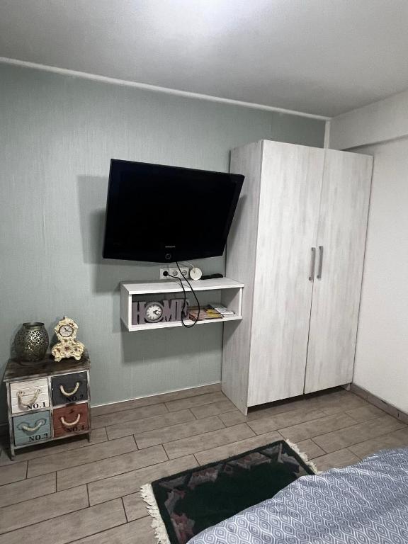 a living room with a flat screen tv on a wall at Hostel Tuzla in Tuzla