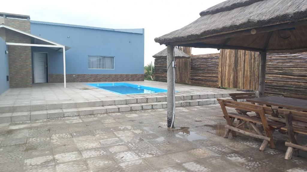 a patio with a bench and a swimming pool at Quinta elescano in Junín