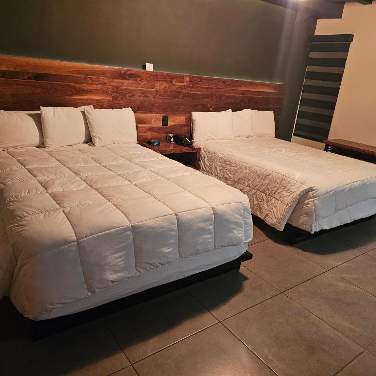 Postel nebo postele na pokoji v ubytování HOTEL RIO RITA