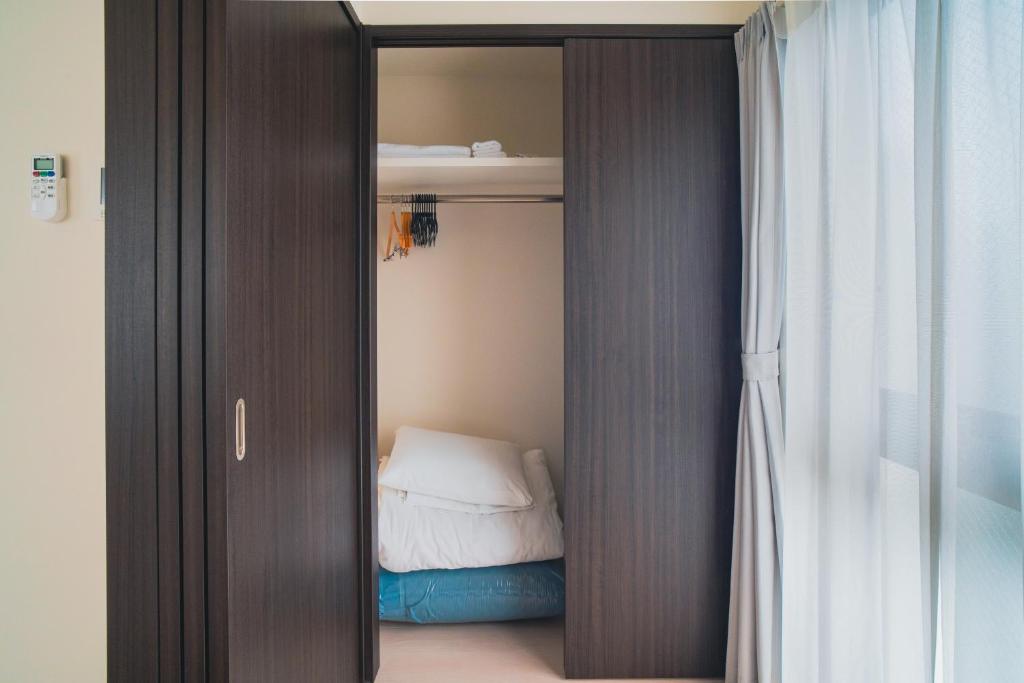 Postel nebo postele na pokoji v ubytování Star Residence - 博多上呉服