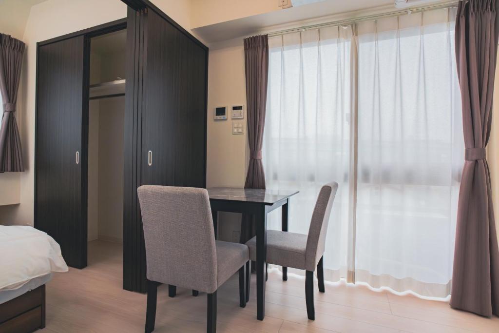Postel nebo postele na pokoji v ubytování Star Residence - 博多上呉服