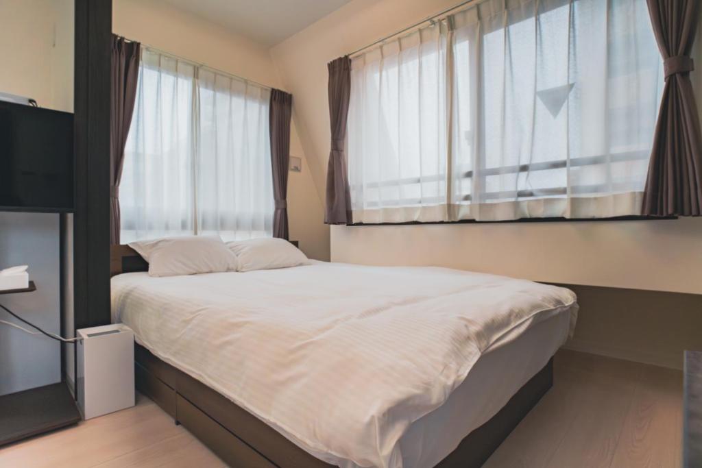Postel nebo postele na pokoji v ubytování Star Residence - 博多上呉服
