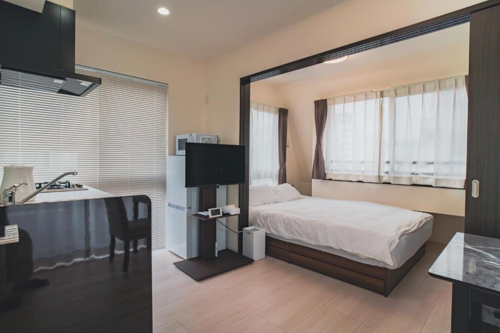 Postel nebo postele na pokoji v ubytování Star Residence - 博多上呉服