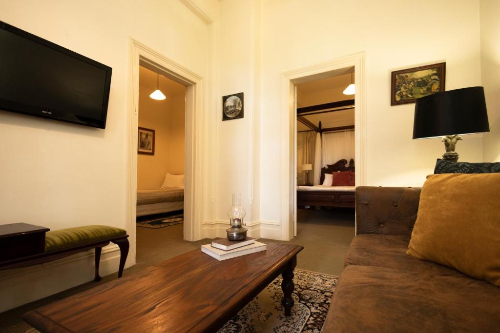 a living room with a couch and a coffee table at Leura House in Leura