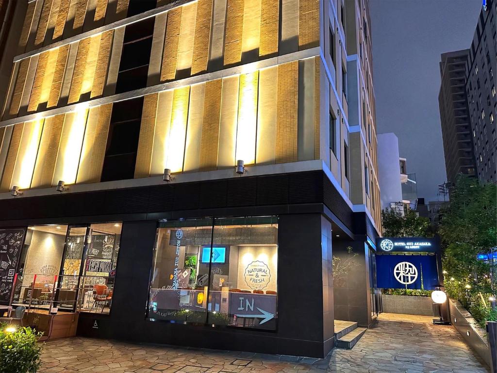 a store front of a building at night at HOTEL SUI AKASAKA by ABEST in Tokyo