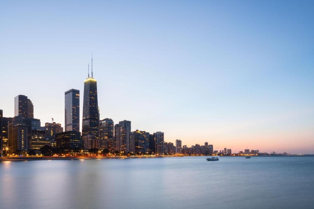 a city skyline from the water at dusk at The Ritz-Carlton, Chicago in Chicago