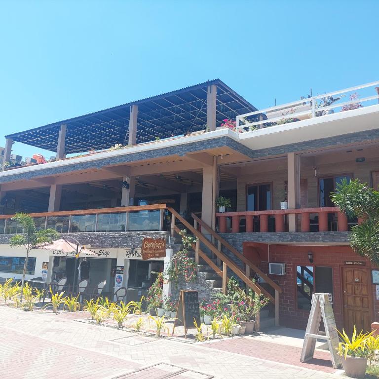un edificio con un restaurante con balcón en captngreggs dive resort, en Puerto Galera
