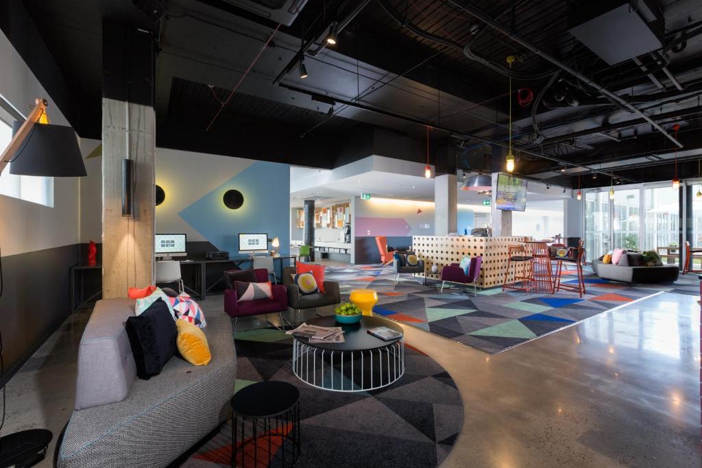 a living room with a couch and chairs and a table at Atura Dandenong in Dandenong