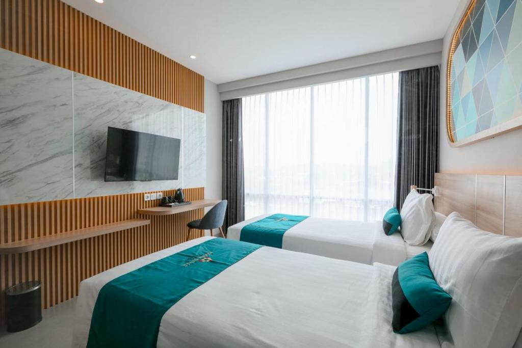 Postel nebo postele na pokoji v ubytování Azana Style Hotel Tulungagung