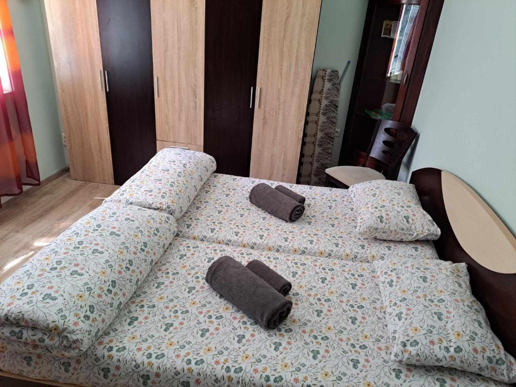 a bed with two pillows on top of it at Zoev in Plovdiv