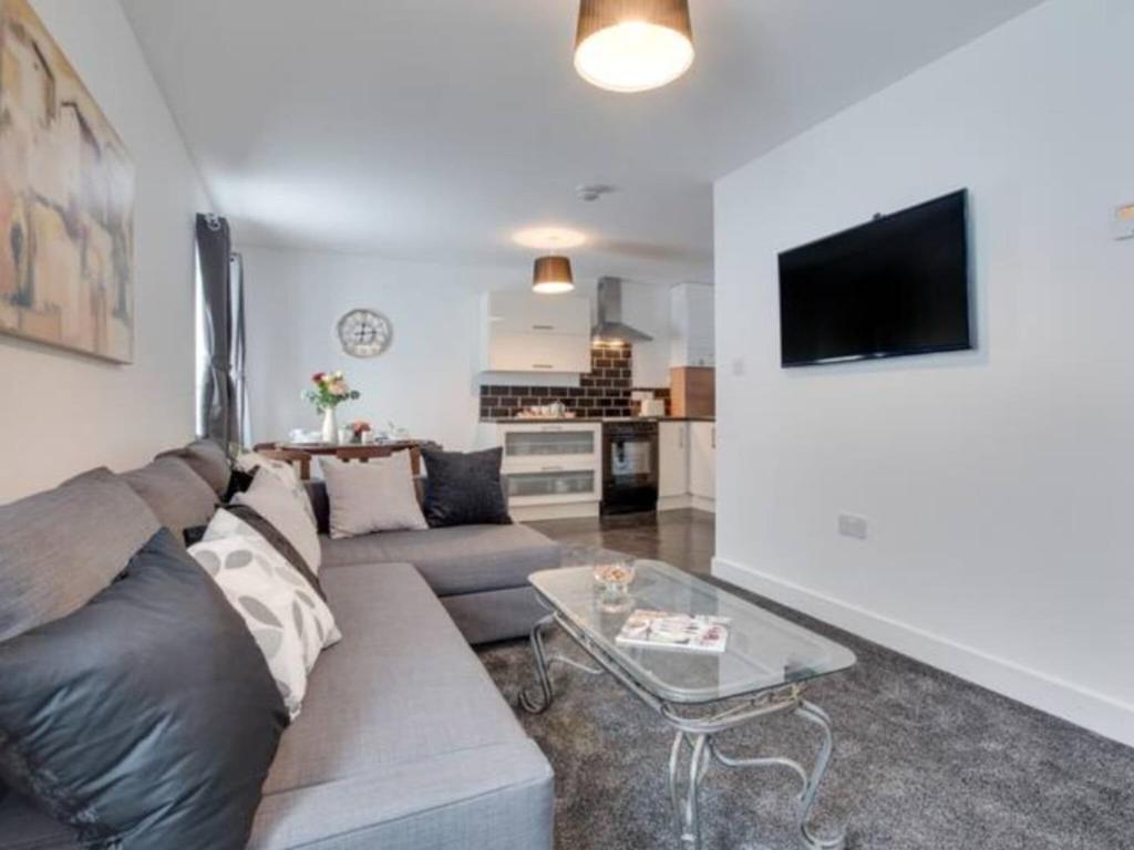 a living room with a couch and a table at Cove Hideaway 1bhk Apt 10 in Skinningrove in Skinningrove