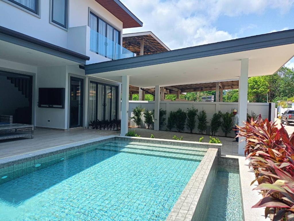 a villa with a swimming pool and a house at Zensiri pool villa Koh Chang in Ko Chang
