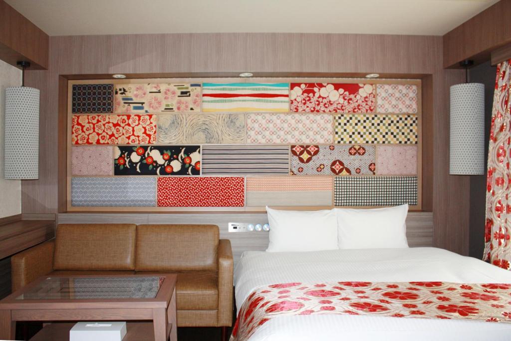 a bedroom with a bed and a wall with a painting at hotel VR osaka in Osaka