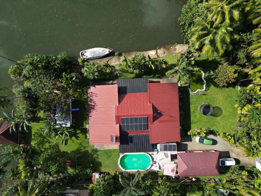 an aerial view of a house in the water at Orchid Island one bedroom Bure in Pacific Harbour