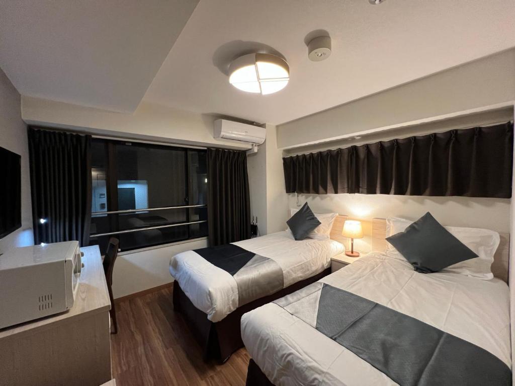 Postel nebo postele na pokoji v ubytování Le Tour Hotel Akihabara Kanda 楽途ホテル神田秋葉原