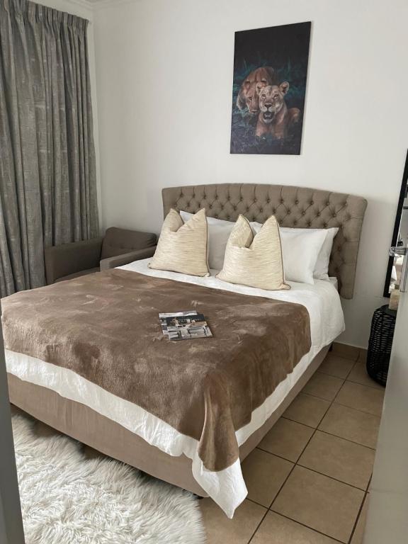 a bedroom with a large bed with a brown blanket at The Perfect Escape in Johannesburg