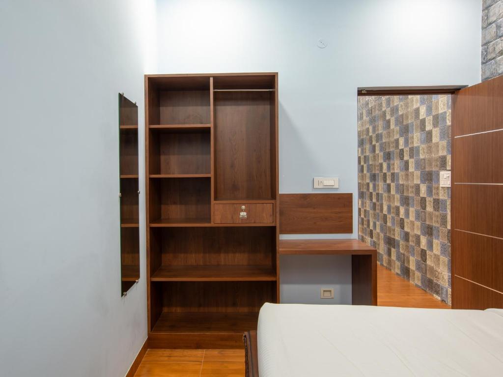 Postel nebo postele na pokoji v ubytování MUGUNDAN 'S SMART STAY