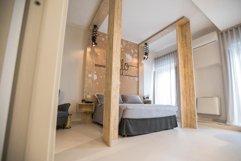 Postel nebo postele na pokoji v ubytování Albergo Diffuso Dimora Rossi Suite B&B