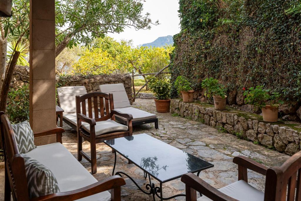 a group of chairs and tables on a patio at Ca's Xorc Luxury Retreat - ADULTS ONLY in Sóller