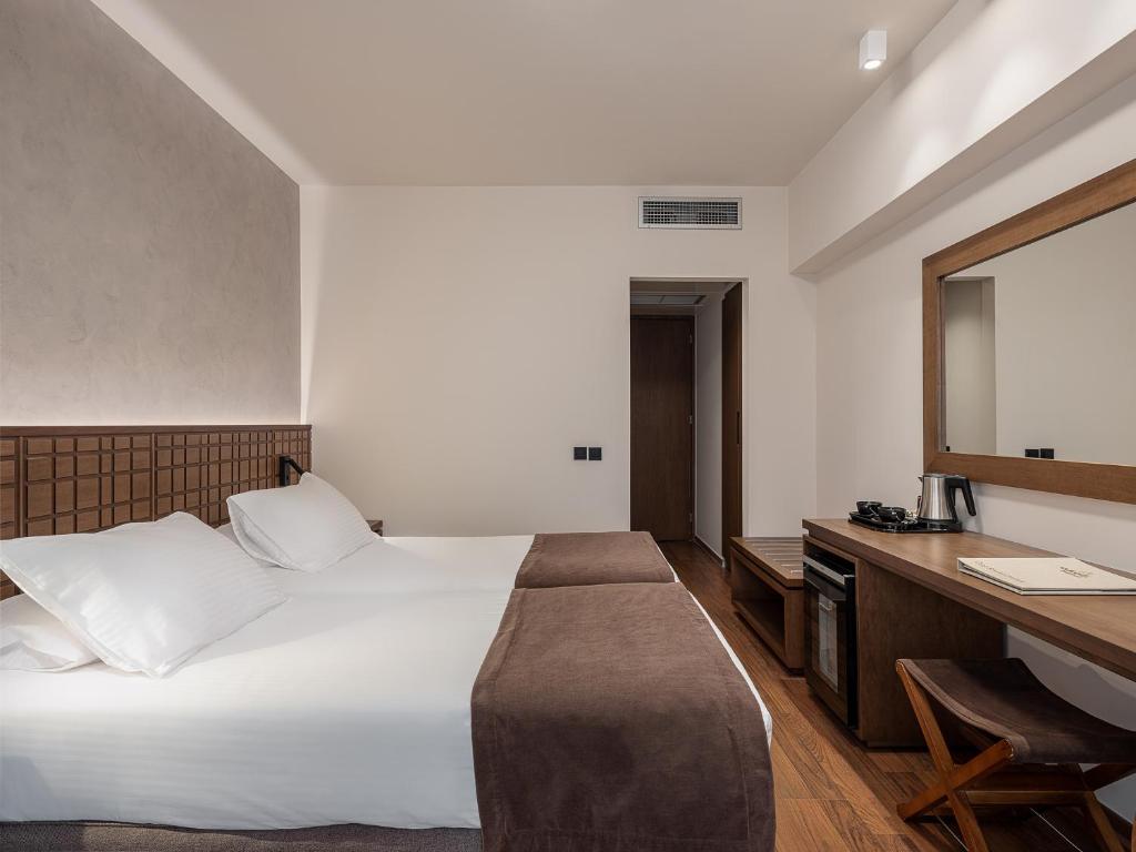 Postel nebo postele na pokoji v ubytování Civitel Akali Hotel