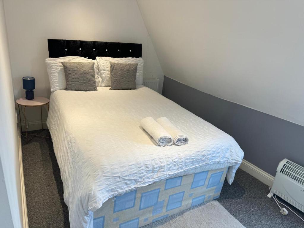 a bedroom with a bed with two towels on it at Comfortable City Centre Room in Bristol