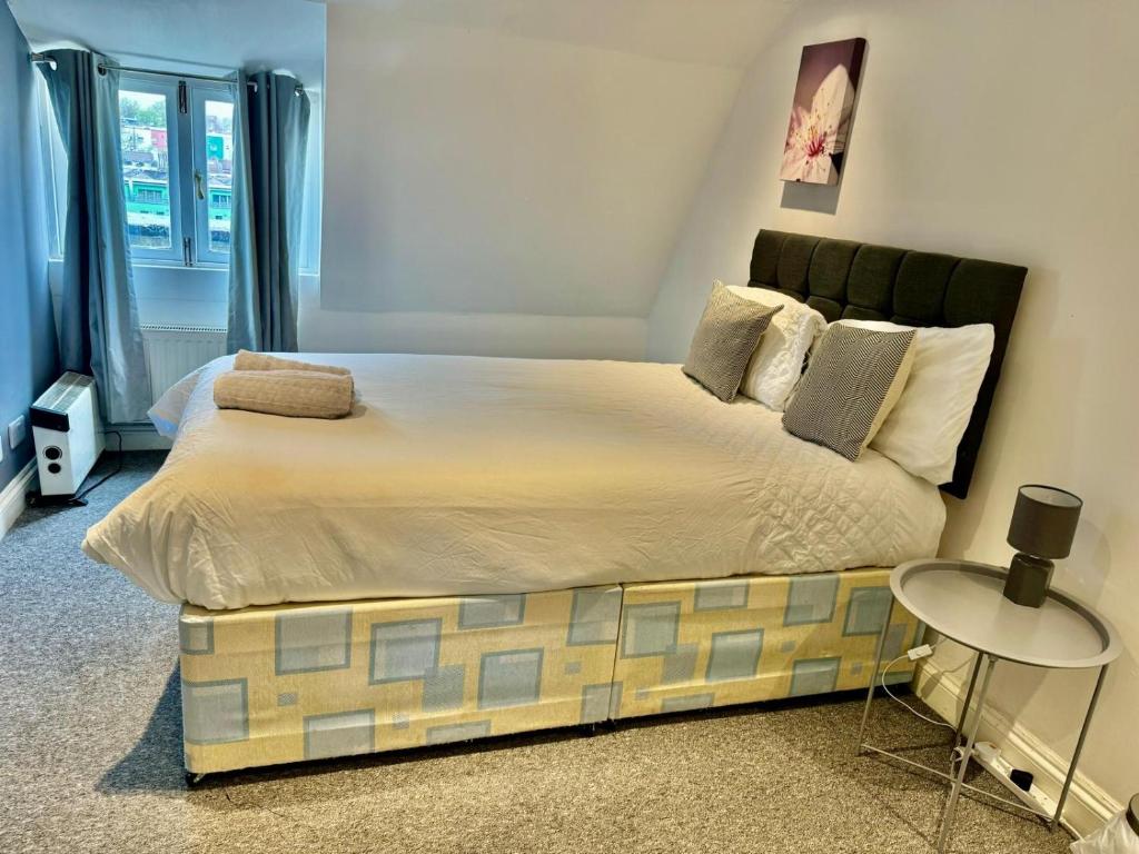a bedroom with a large bed with a side table at Large City Centre Room in Bristol